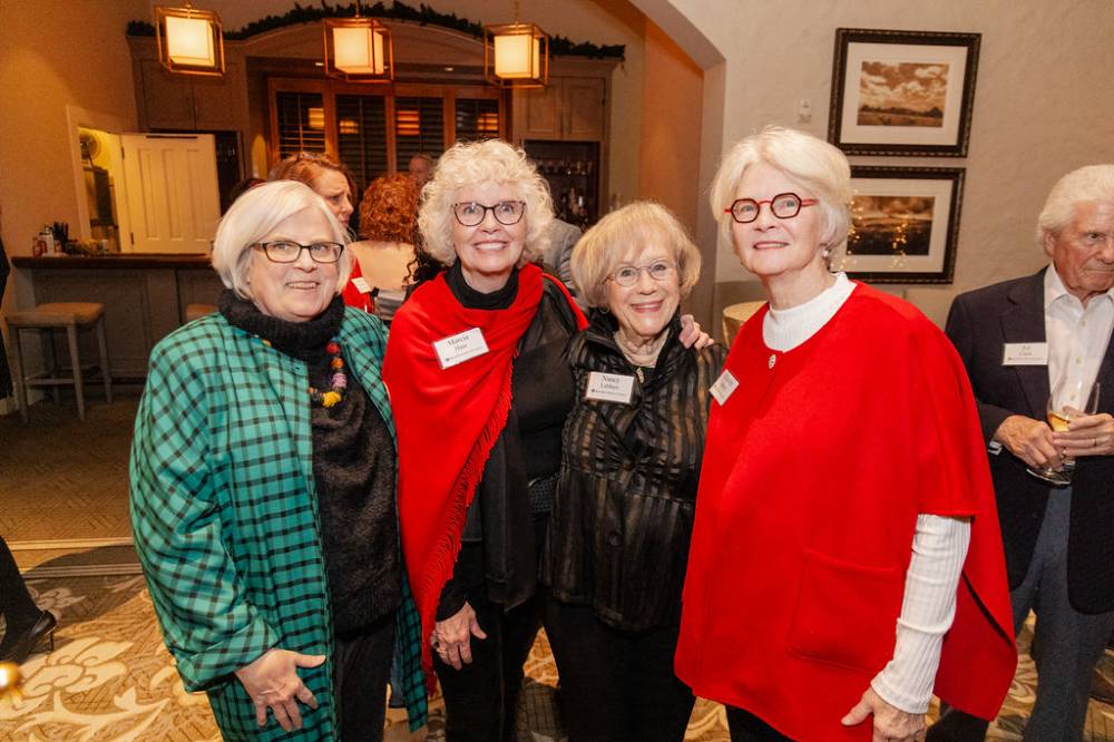Four women standing together and smiling for camera, including First Ladies Haas, Lubbers, and Murray